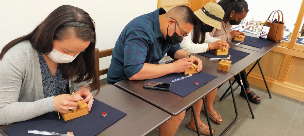 Participant doing the tenkoku workshop. Stone Carving