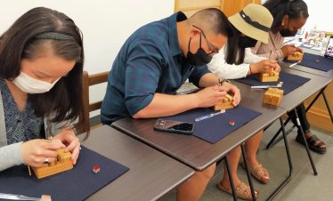 Participant doing the tenkoku workshop. Stone Carving