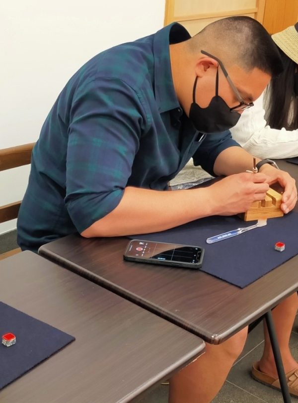 Participant doing the tenkoku workshop. Stone Carving